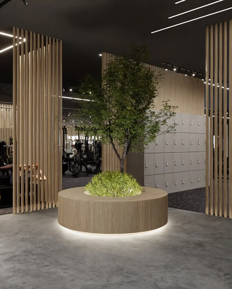 Ingresso della sala pesi con un albero in un'aiuola di legno