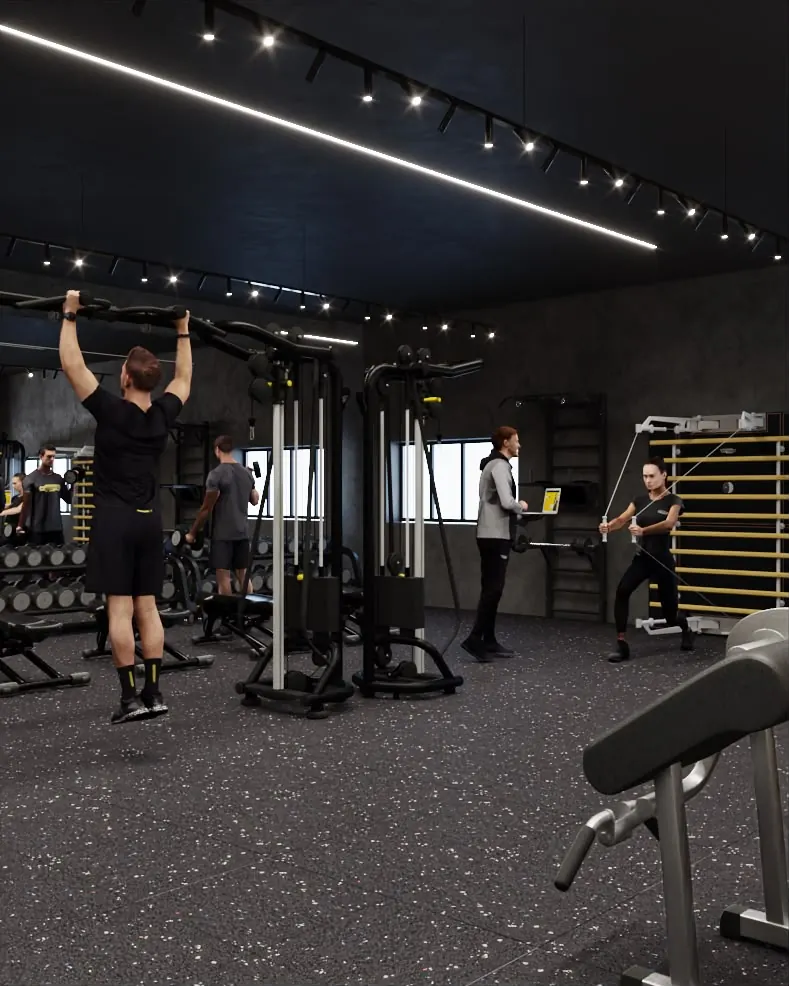 Sala pesi con trainer che segue gli iscritti ai cavi